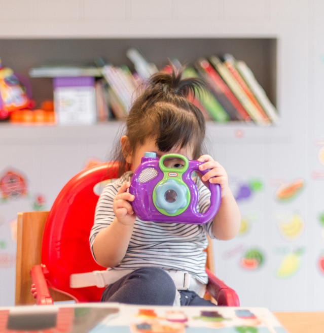 Bébé jouant dans une aire dédiée avec des jouets